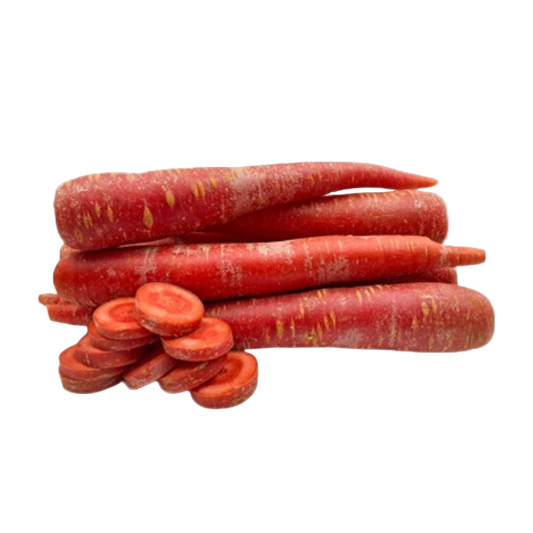 Red carrots with a few sliced on a white background